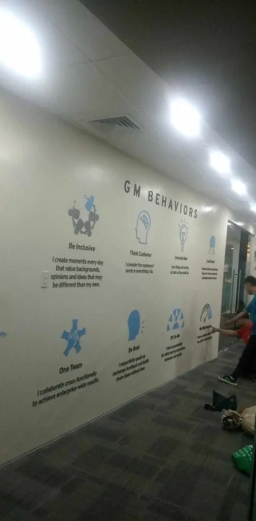 GM Behaviors office metal signage for General Motors in Makati, with icons and staff working. by M&G Global Ads.