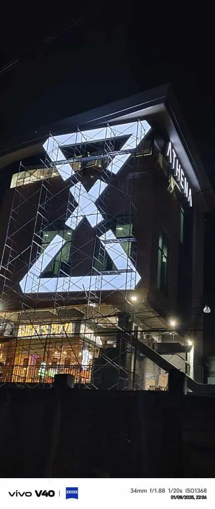 ATHENA indoor signage and illuminated geometric displays at a modern building in Makati at night by M&G Global Ads.