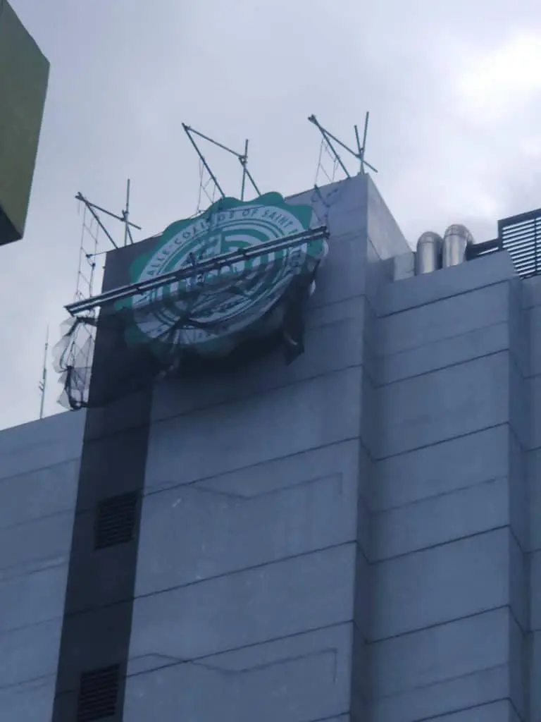 LED building signage installation on top of a tall gray building in Ortigas under construction by M&G Global Ads.