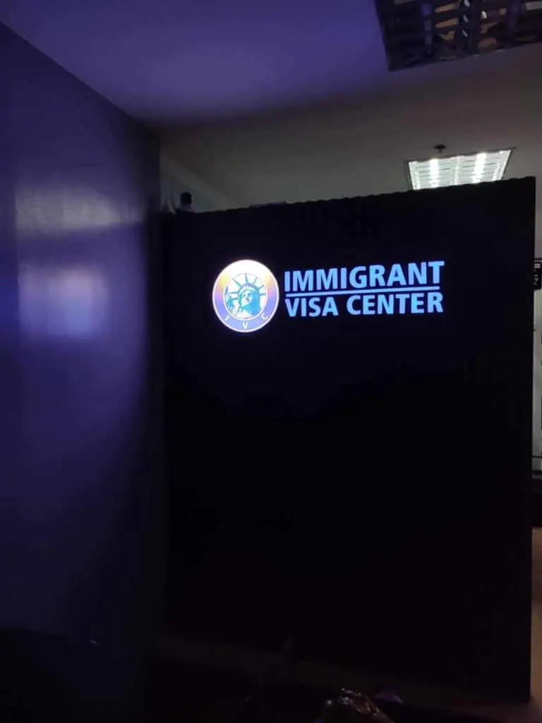 LED indoor signage for Immigrant Visa Center with Statue of Liberty logo in Makati, dimly lit room by M&G Global Ads.