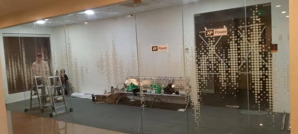 XP Power acrylic signage installation in a glass-walled Makati office under construction by M&G Global Ads.