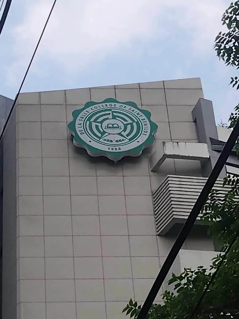 De La Salle College of Saint Benilde circular outdoor signage on a modern building in Makati by M&G Global Ads.