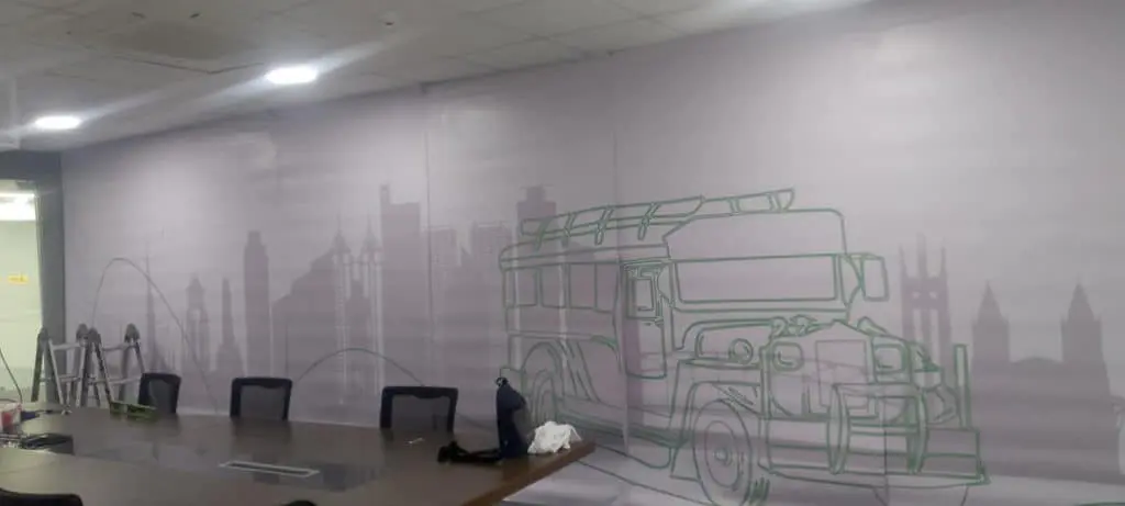 Acrylic signage in a modern conference room with jeepney mural, table and chairs in Makati by M&G Global Ads.