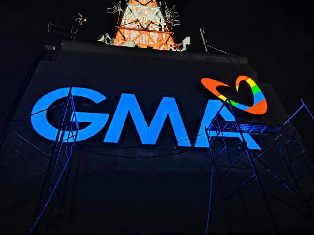 Outdoor building signage of the illuminated GMA logo with heart symbol in Metro Manila by M&G Global Ads.