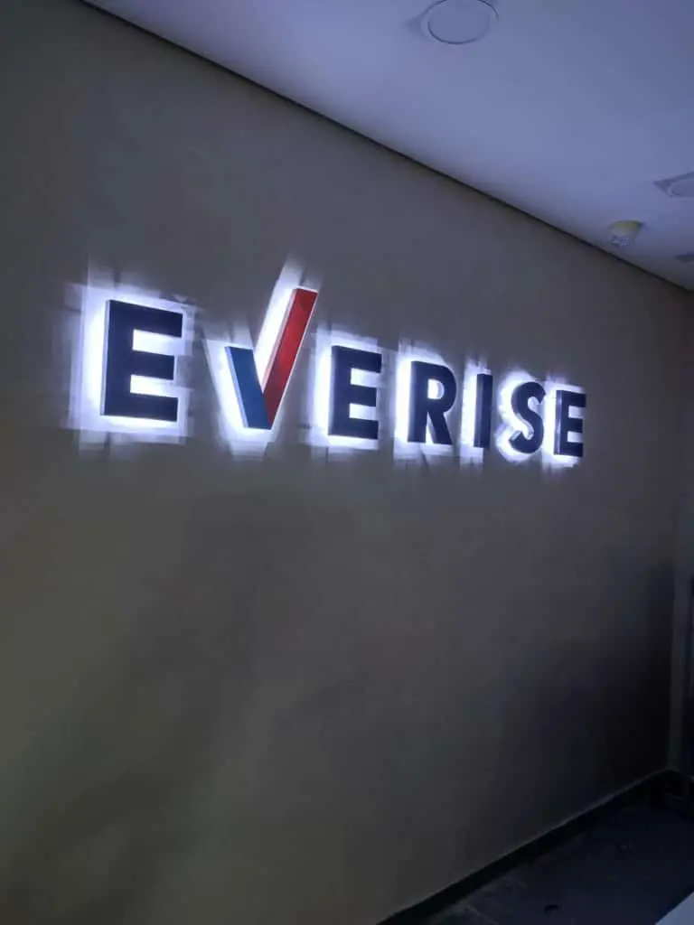EVERISE illuminated office signage, metallic letters, red V accent, gray wall background in Ortigas by M&G Global Ads.