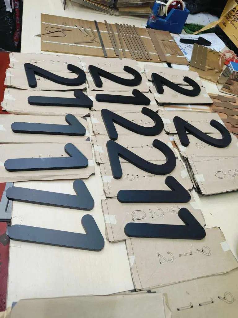 LED signage numbers fabrication with templates and tools on table in Quezon City workshop by M&G Global Ads.