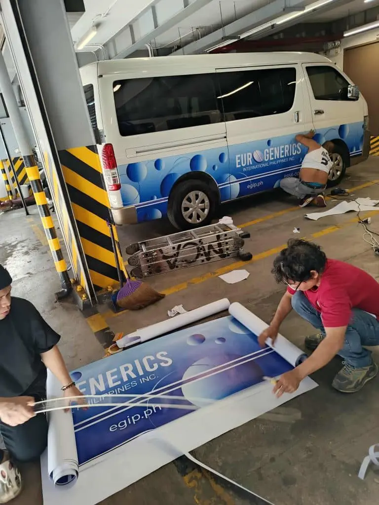 Vehicle decal installation for EURO GENERICS in a Makati parking garage, printed graphics visible, by M&G Global Ads.