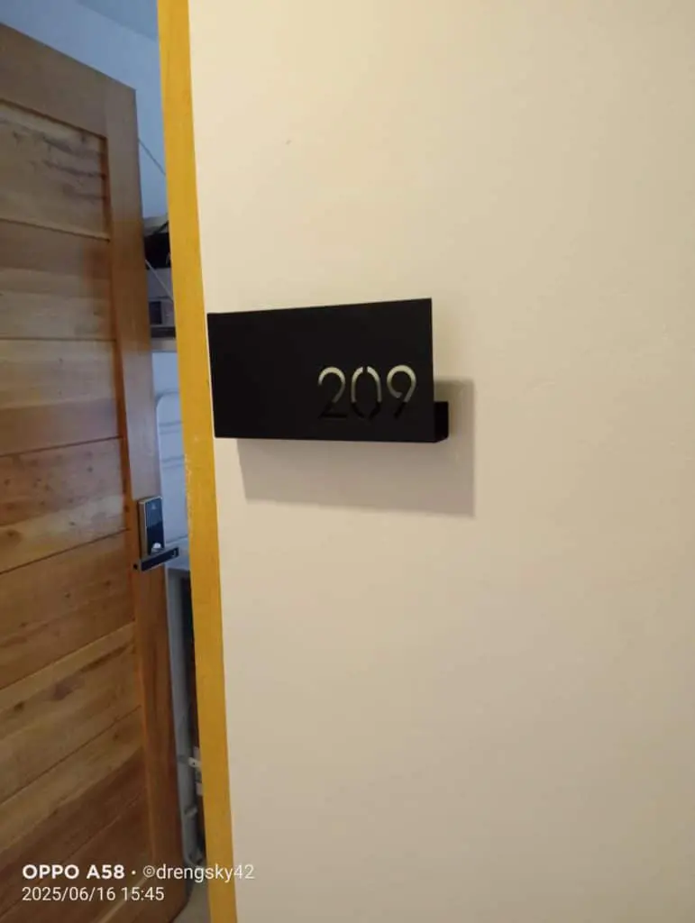 Room number signage 209 in metallic letters on black plaque by door in Ortigas, Metro Manila, by M&G Global Ads.