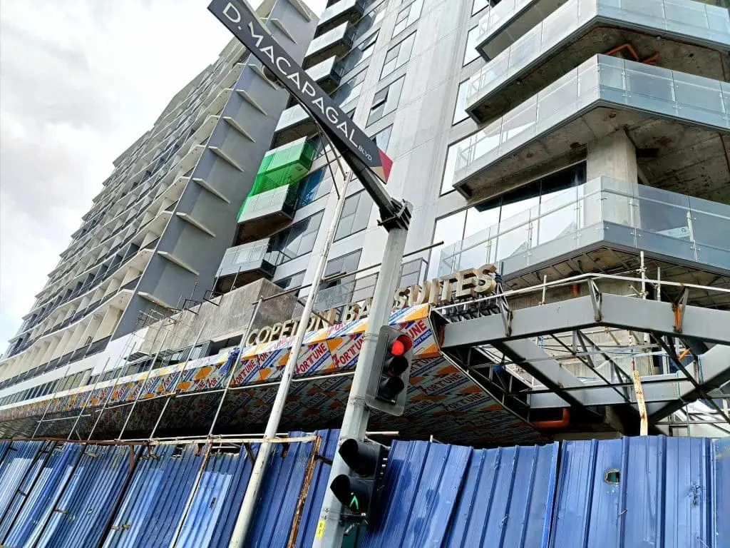 Outdoor signage for CORTE IN BIZ SUITES on a glass building in Mandaluyong by M&G Global Ads.