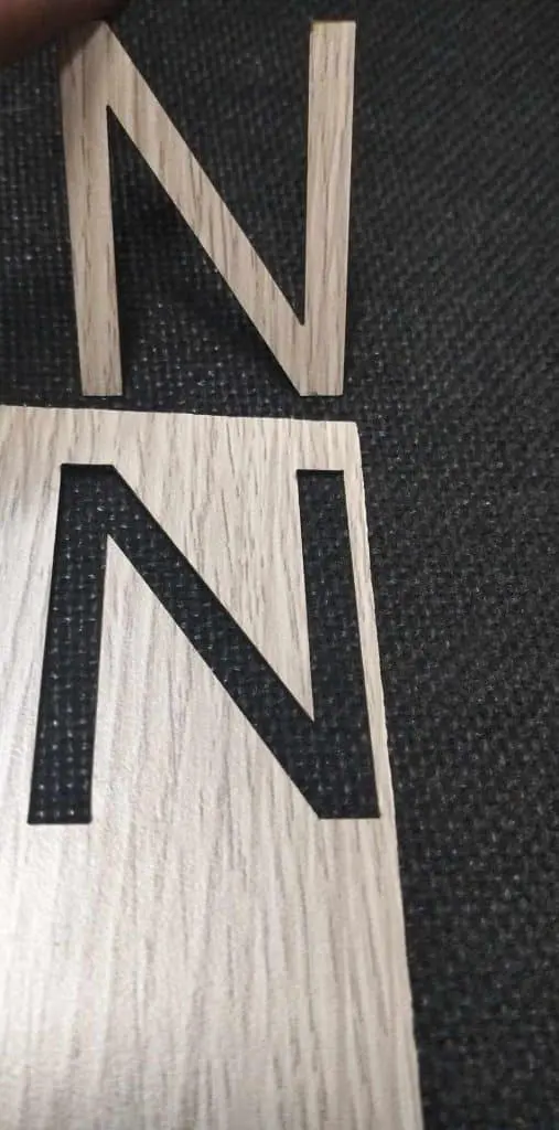 Wooden indoor signage letter N cutout over matching board on dark surface, ideal for offices in Mandaluyong by M&G Global Ads.