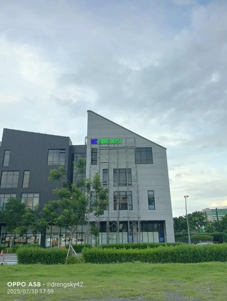 HOM DEPOT green building signage installation on modern building with scaffolding in Quezon City by M&G Global Ads.