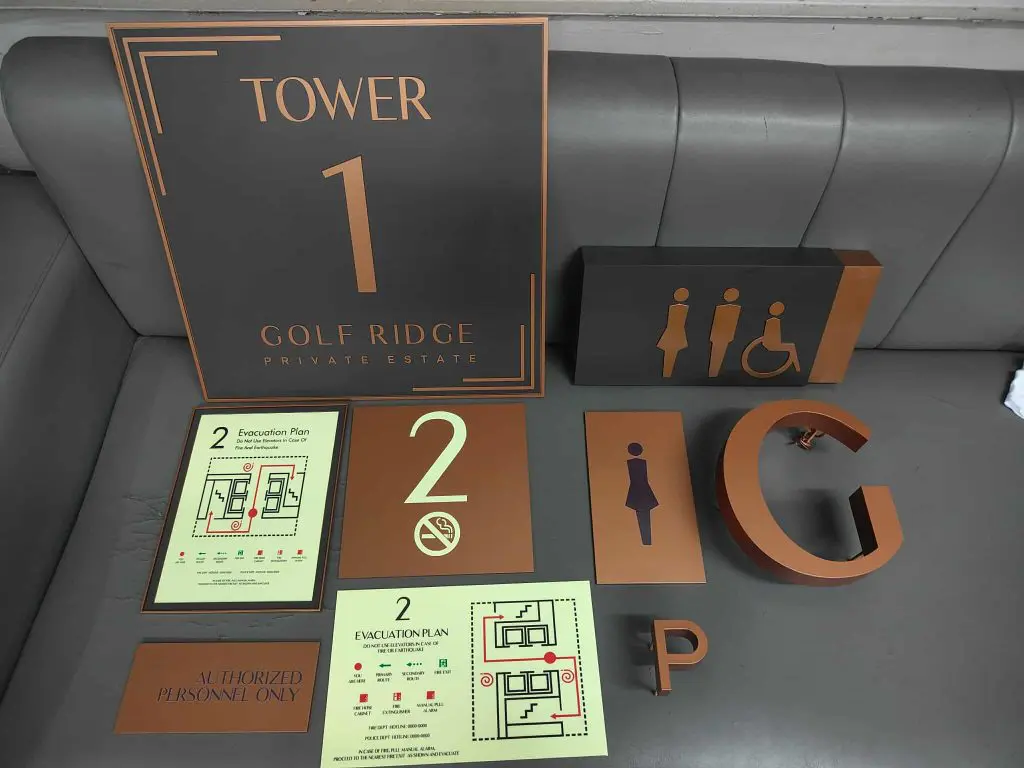 Bronze and black building signage, including restroom, floor numbers, evacuation plans in Mandaluyong by M&G Global Ads.