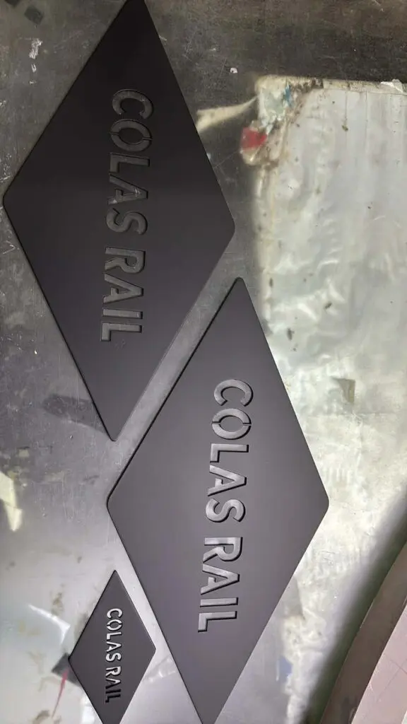 Stainless steel building signage for COLAS RAIL, diamond-shaped plaques, Metro Manila sign maker Philippines by M&G Global Ads.