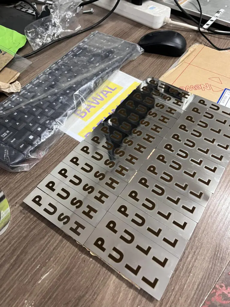 Stainless steel letter stencils for indoor signage on wooden desk, sign maker Philippines, Metro Manila by M&G Global Ads.