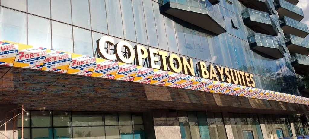 COPETON BAY SUITES acrylic building signage, Fortune exterior wrap, modern glass building, Metro Manila—sign maker Philippines by M&G Global Ads.
