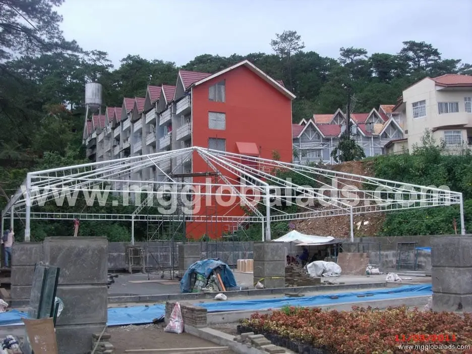Building signage with metal framework under construction at a red multi-story building, Metro Manila, sign maker Philippines by M&G Global Ads.