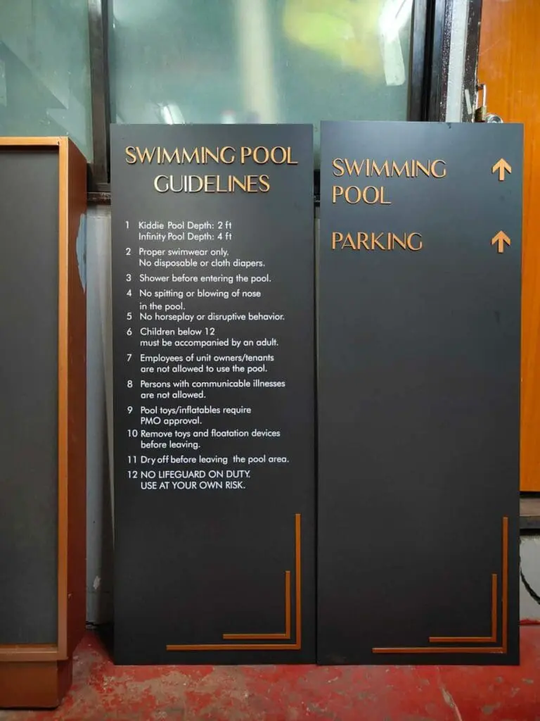 Swimming pool safety guidelines and parking wayfinding acrylic signage, black with orange and white text, Metro Manila. Sign maker Philippines by M&G Global Ads.