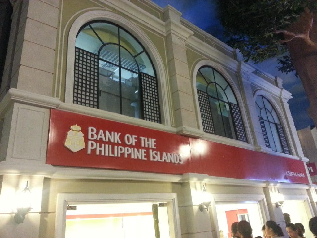 Bank of the Philippine Islands LED signage at a two-story building in Makati, entrance lit, people nearby, by M&G Global Ads.
