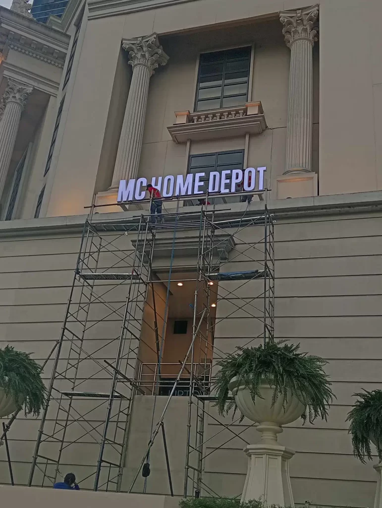 MC HOME DEPOT outdoor signage installation on classical building facade in Quezon City by M&G Global Ads.