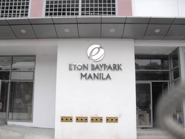Eton Baypark Manila acrylic building stainless signage with stylized e logo at entrance in Makati by M&G Global Ads.