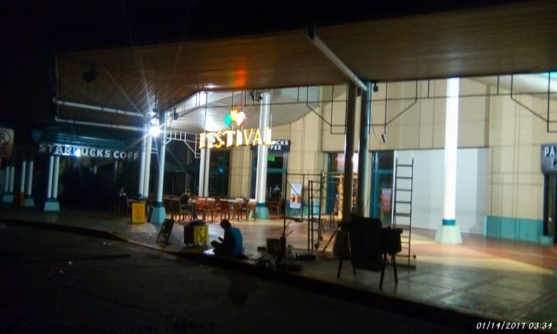Festival supermarket front acrylic signage and Starbucks Coffee sign in Makati at night, workers visible; by M&G Global Ads.