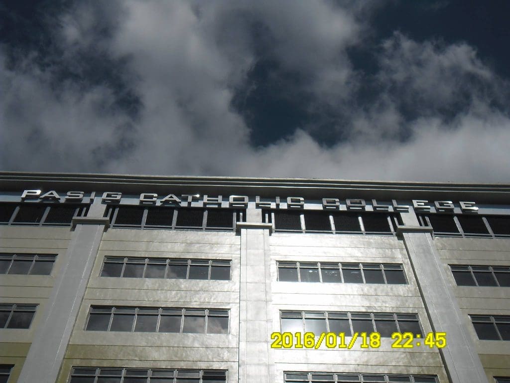 LED signage for Pasig Catholic College facade in Pasig City, seen from below; date and time visible. by M&G Global Ads.