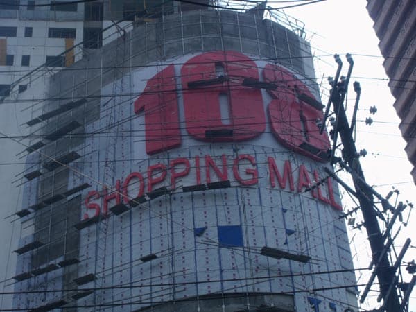Shopping mall facade building signage with large red 188, scaffolding, in Makati, by M&G Global Ads.