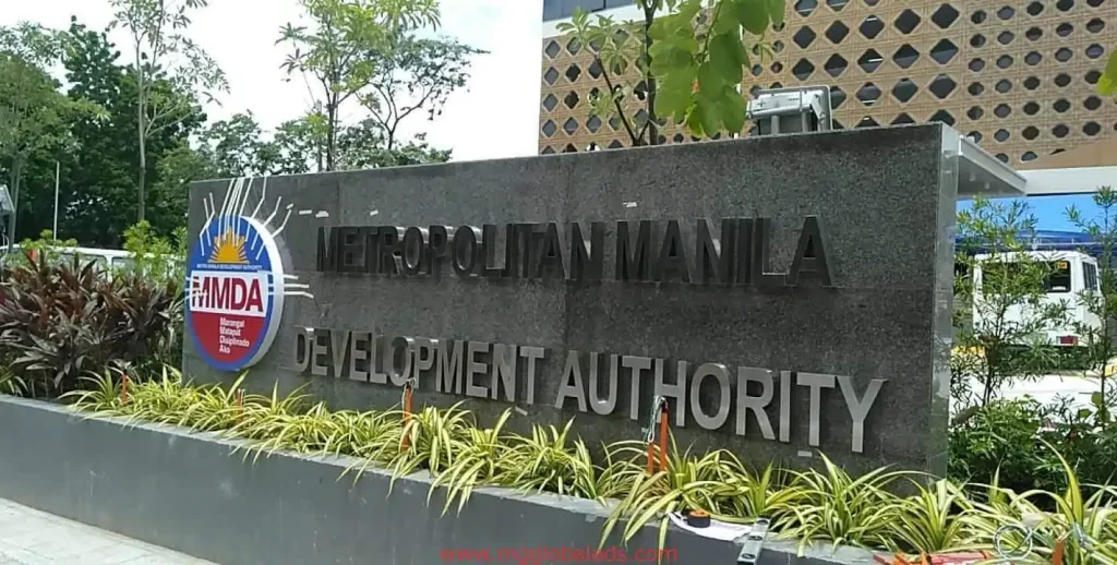 MMDA large stone signage for Metropolitan Manila Development Authority in Makati, beside plants and building, by M&G Global Ads.