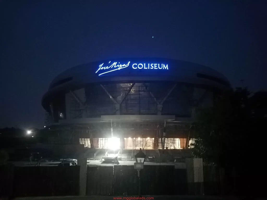 LED signage for Jose Noyes COLISEUM at night, Quezon City, glowing above entrance with lit interior by M&G Global Ads.