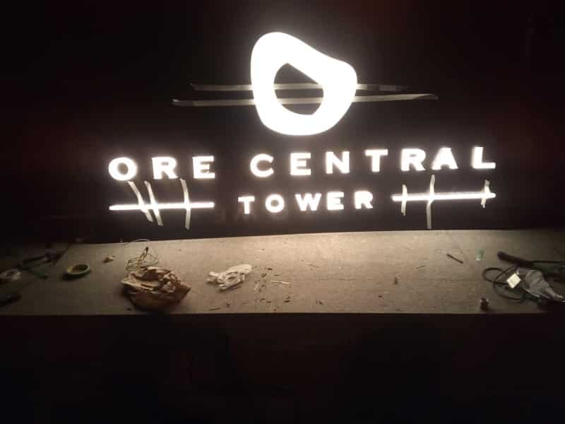 LED illuminated acrylic building signage for ORE CENTRAL TOWER in BGC at night with abstract logo, by M&G Global Ads.