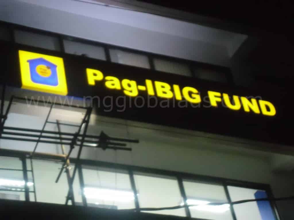 Pag-IBIG Fund LED signage with yellow house logo on building at night in Quezon City, by M&G Global Ads.