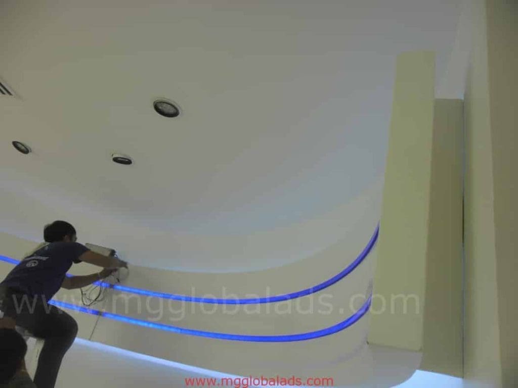 Indoor LED strip ceiling signage installation in an office in Makati, with modern lighting by M&G Global Ads.