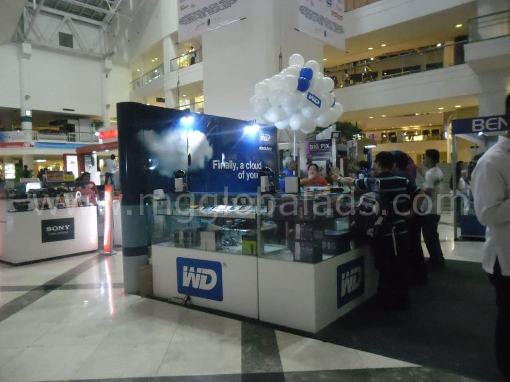 Western Digital booth with indoor signage and white balloons in Makati mall, showcasing storage devices by M&G Global Ads.
