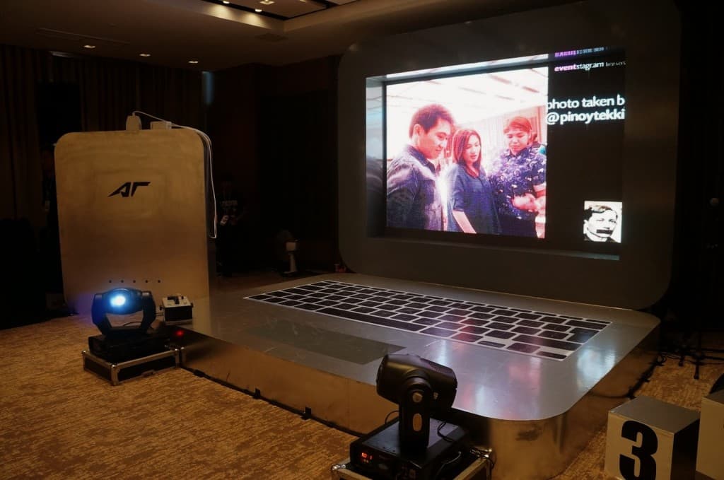 Acrylic event signage and stage prop laptop with oversized keyboard in Makati, surrounded by lighting—by M&G Global Ads.