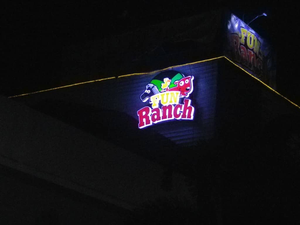 Fun Ranch outdoor building signage in Ortigas with cartoon animal faces and yellow lights at night by M&G Global Ads.