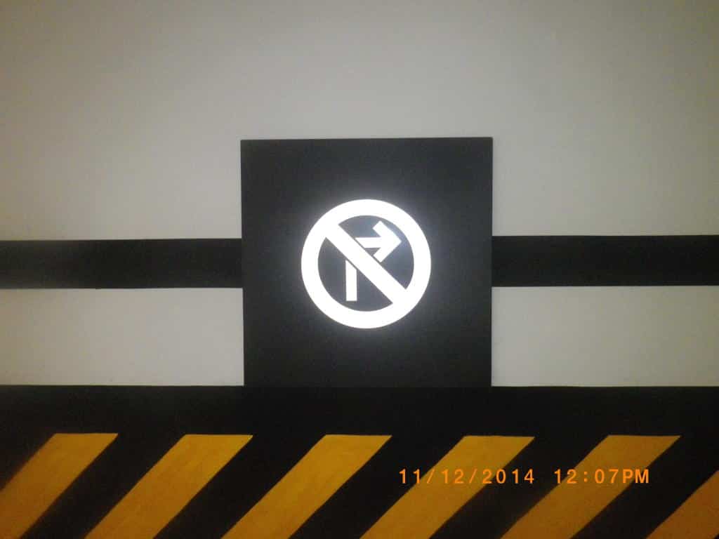 No right turn traffic sign, wall-mounted in Makati with yellow-black stripes, by M&G Global Ads.