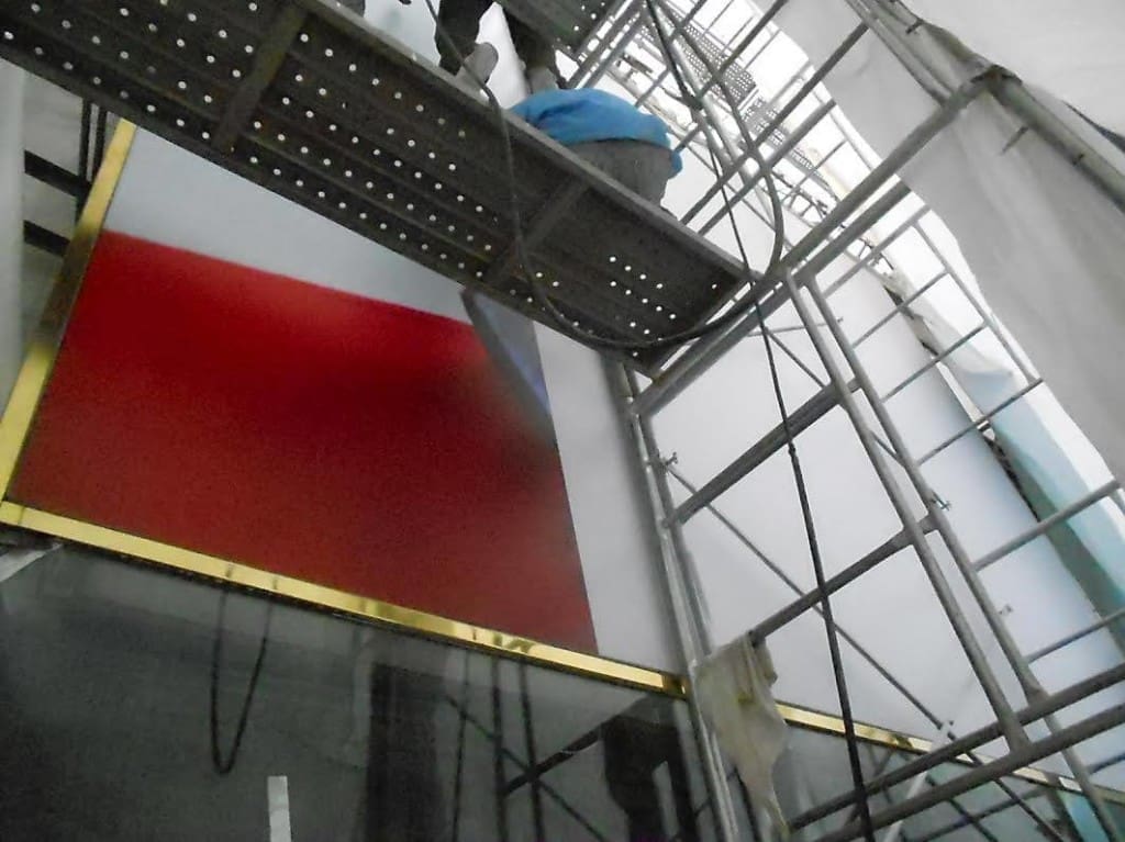 Acrylic signage installation with red-white gradient and gold trim in Ortigas, indoor site work by M&G Global Ads.
