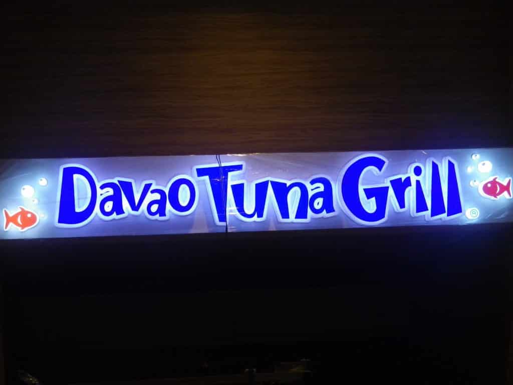 Acrylic outdoor signage for Davao Tuna Grill, blue and white letters with red fish, Makati installation by M&G Global Ads.