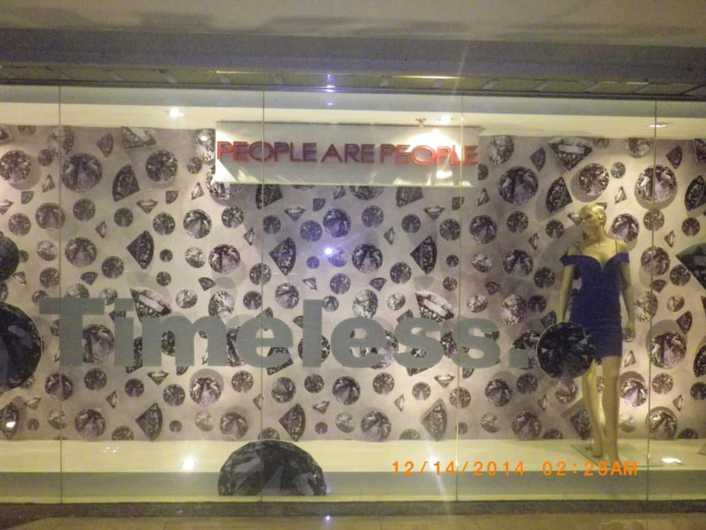 Indoor store signage for People Are People with gem-pattern design and mannequin in blue dress, Makati, by M&G Global Ads.