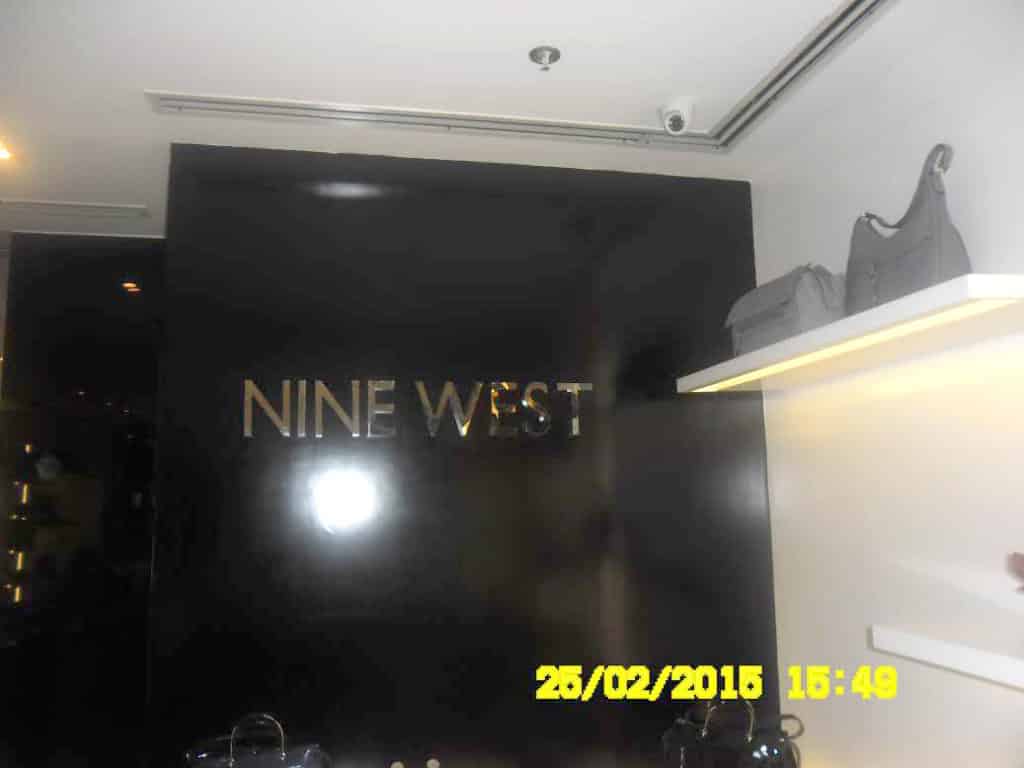 NINE WEST LED signage on glossy black wall, handbags on shelves, Ortigas store interior with date stamp by M&G Global Ads.