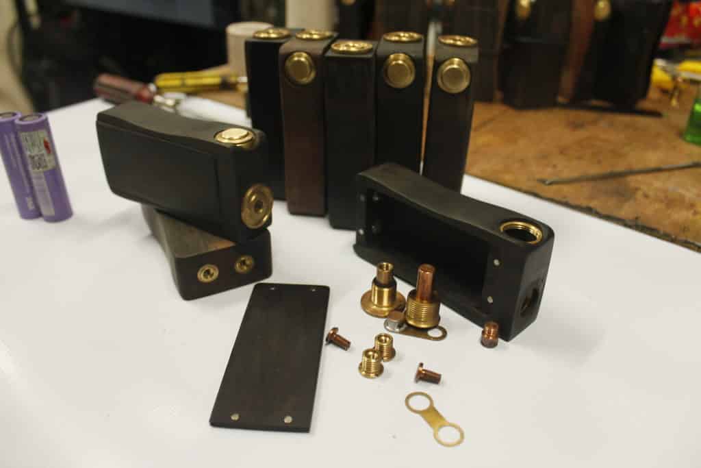 Wooden vape mod boxes, parts, batteries, tools with building signage elements in Makati by M&G Global Ads.