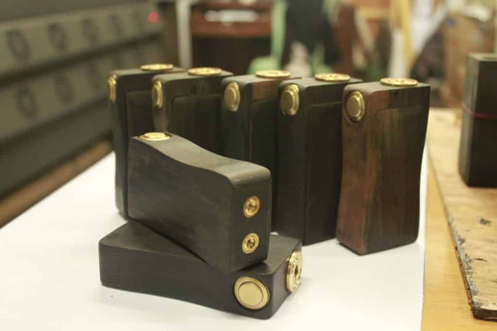 Handcrafted wooden office directional signage with brass buttons, displayed on white surface in Makati by M&G Global Ads.