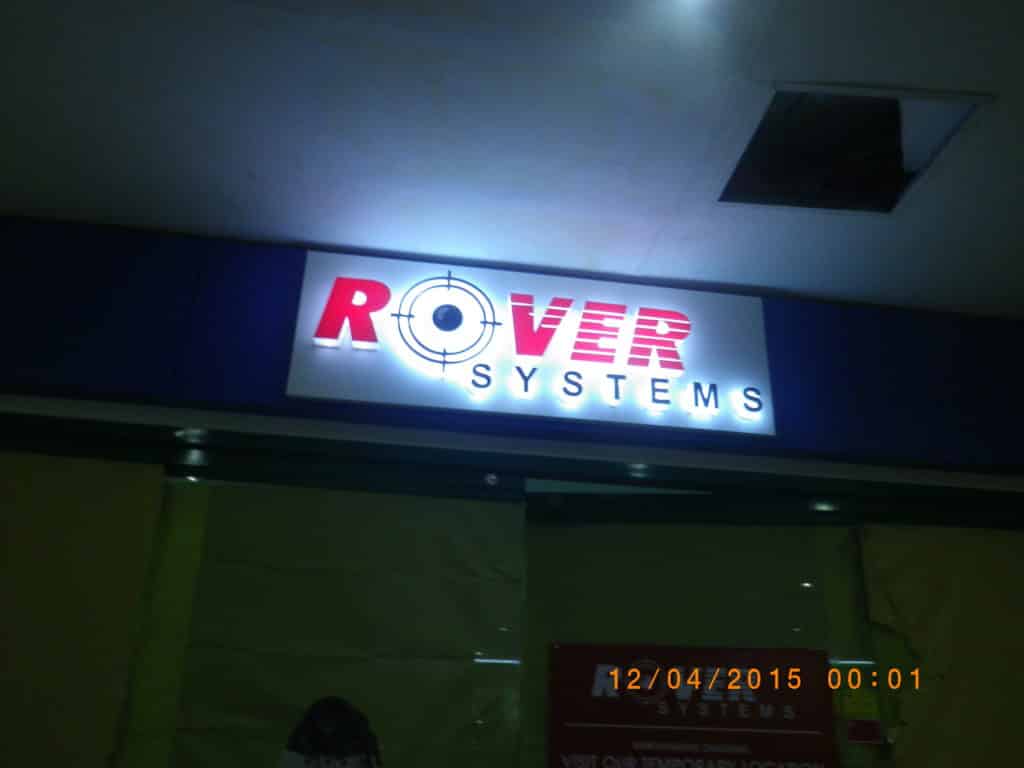 Illuminated indoor signage for Rover Systems with crosshair O, ceiling view, timestamp. Makati location by M&G Global Ads.