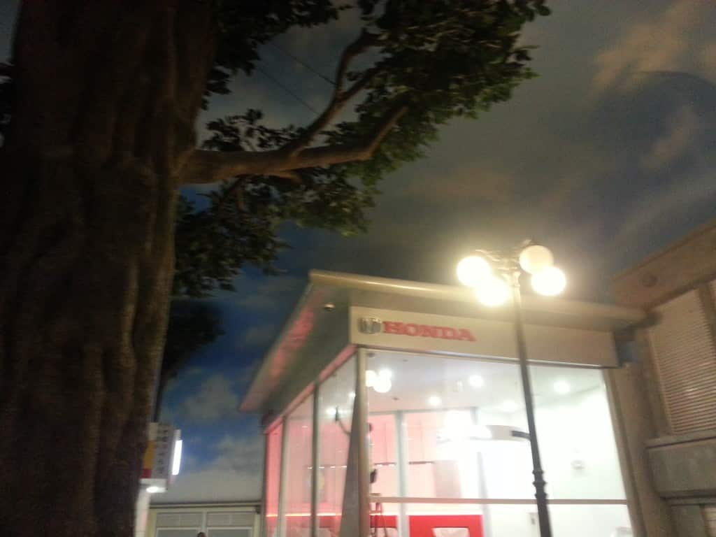 Metallic Honda dealership signage above entrance in Quezon City, with vertical banner at left, by M&G Global Ads.