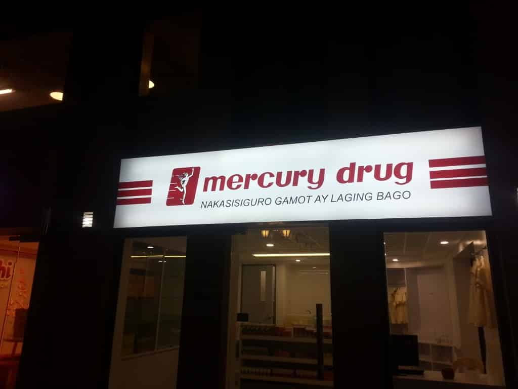 Mercury Drug illuminated building signage in Ortigas at night, red logo, tagline displayed above entrance by M&G Global Ads.