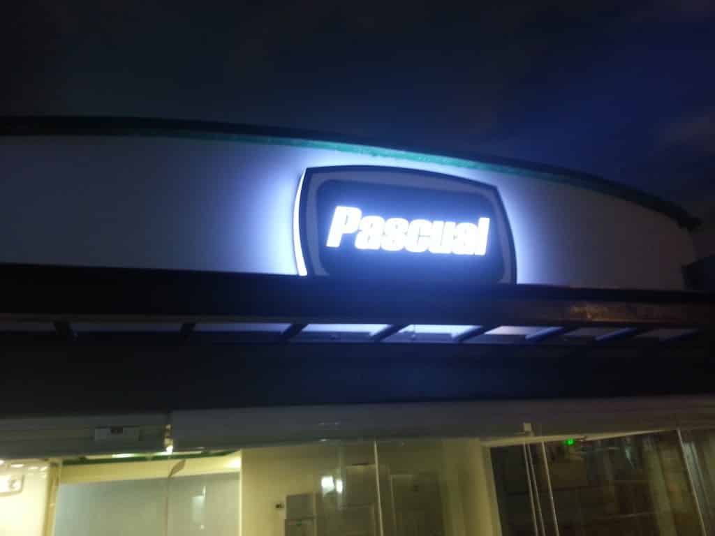 Illuminated acrylic building signage for Pascual in Makati at night, with glass windows, by M&G Global Ads.