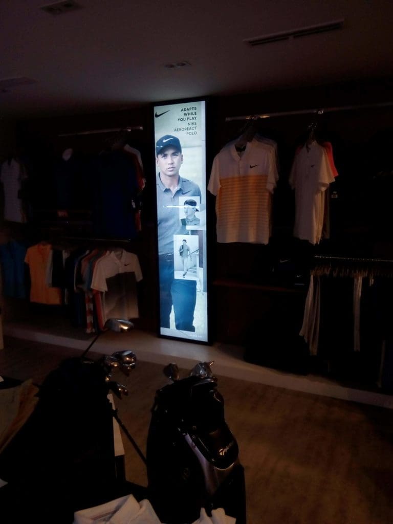 Vertical LED signage for Nike in a clothing store, golf shirts display, Ortigas. Glowing sign with golfer. By M&G Global Ads.