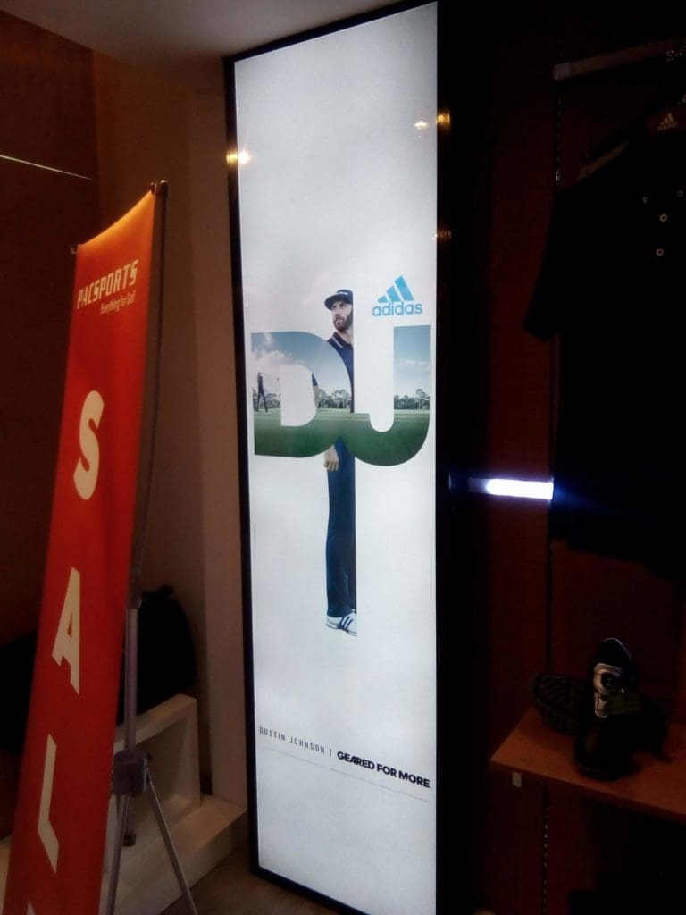 Backlit Adidas LED signage with Dustin Johnson DJ letters in a Makati store, red SALE sign. By M&G Global Ads.