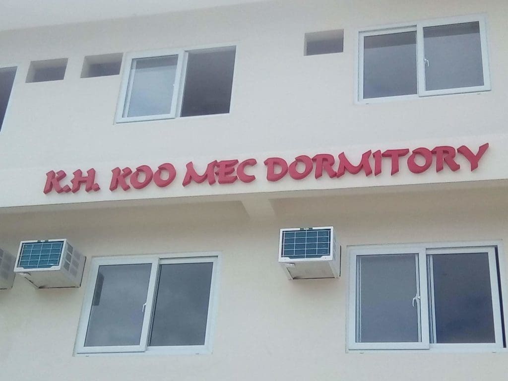 Dormitory building with bold red outdoor signage for K.H. KOO MEC in Quezon City, by M&G Global Ads.