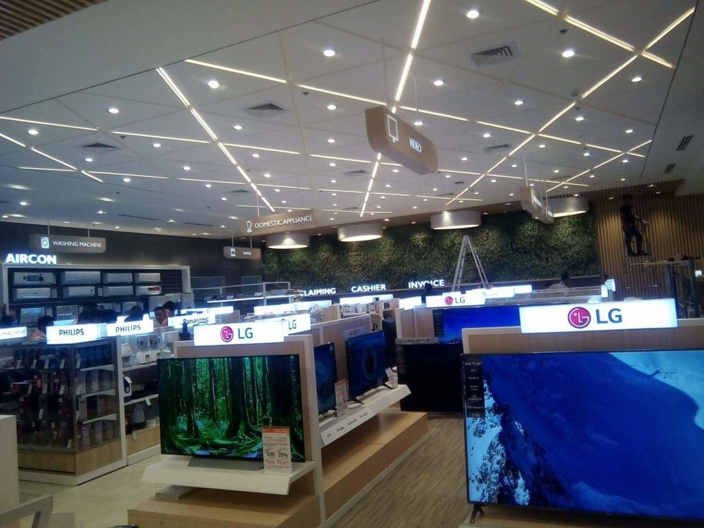 LED signage for Philips, Sony, and LG in an electronics store in Makati with a plant wall. By M&G Global Ads.